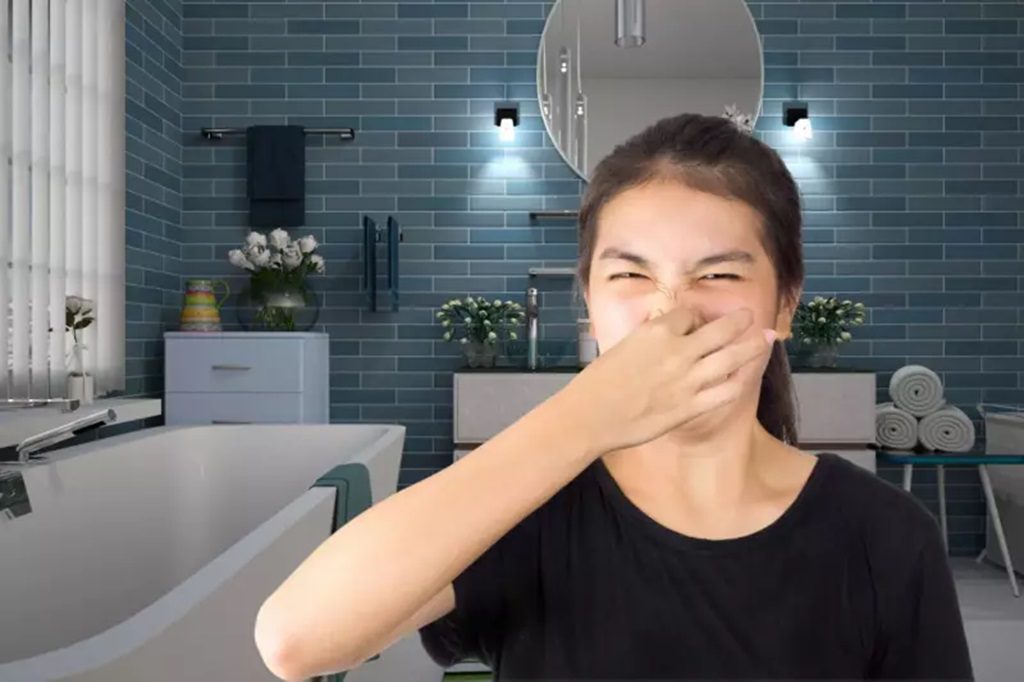 a woman pinching her nose because of smell.