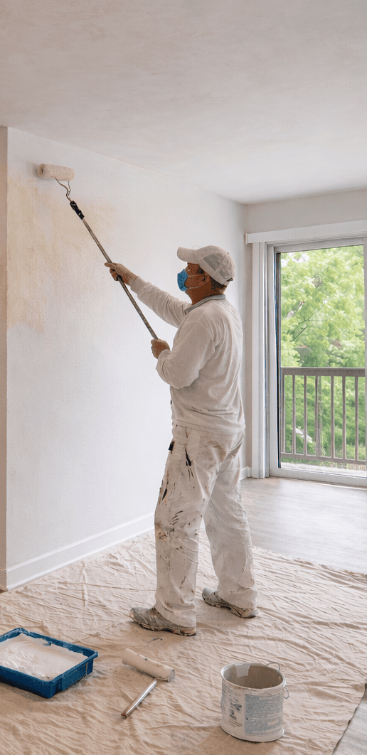 image of a person painting over walls that contain odor.